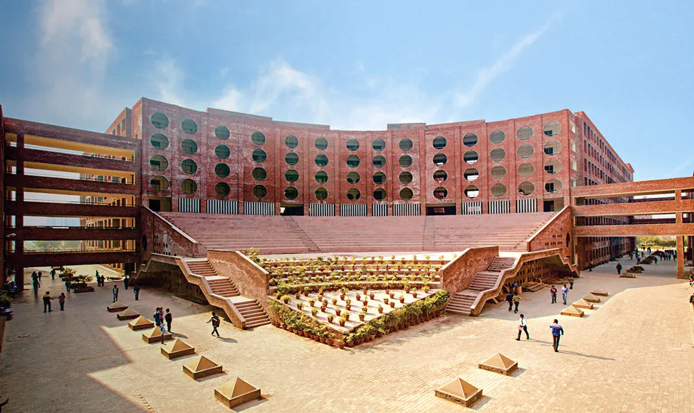LPU's red-brick academic block with round windows, above the stepped open-air theatre
