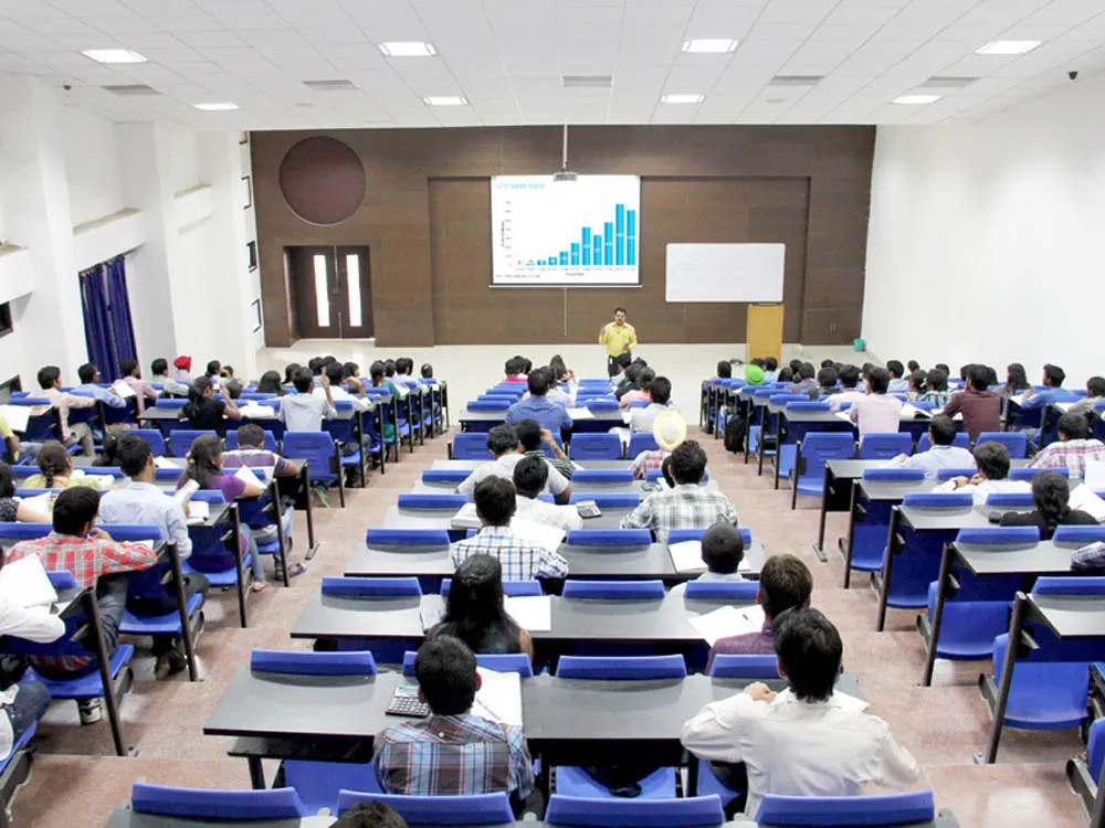 A lecture theatre at LPU, students facing a slide of bar charts
