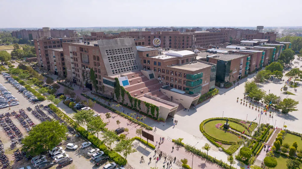 Aerial view of the LPU campus: red-brick academic blocks, lawns and a roundabout